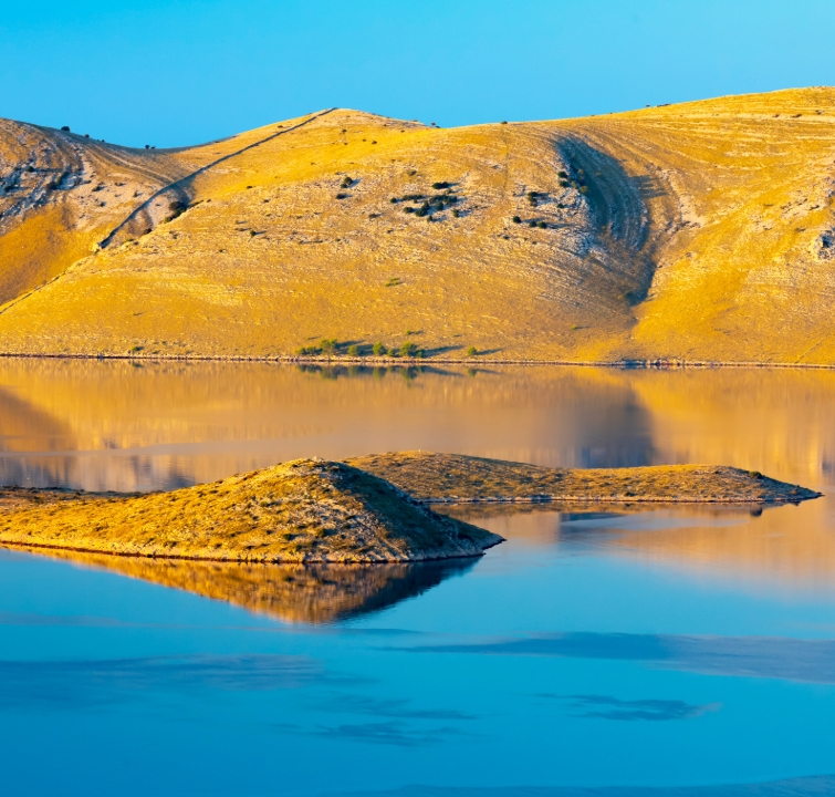 Stille Bucht und goldene Hügel in den Kornaten – abgelegener Ankerplatz beim Yachtcharter mit BlackSails-Yachting